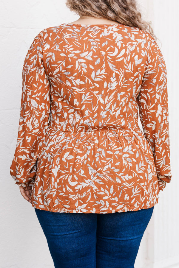 Chic Soul plus size clothing, rust colored long sleeve babydoll style top with leave pattern and slight ruffles at bottom of sleeve