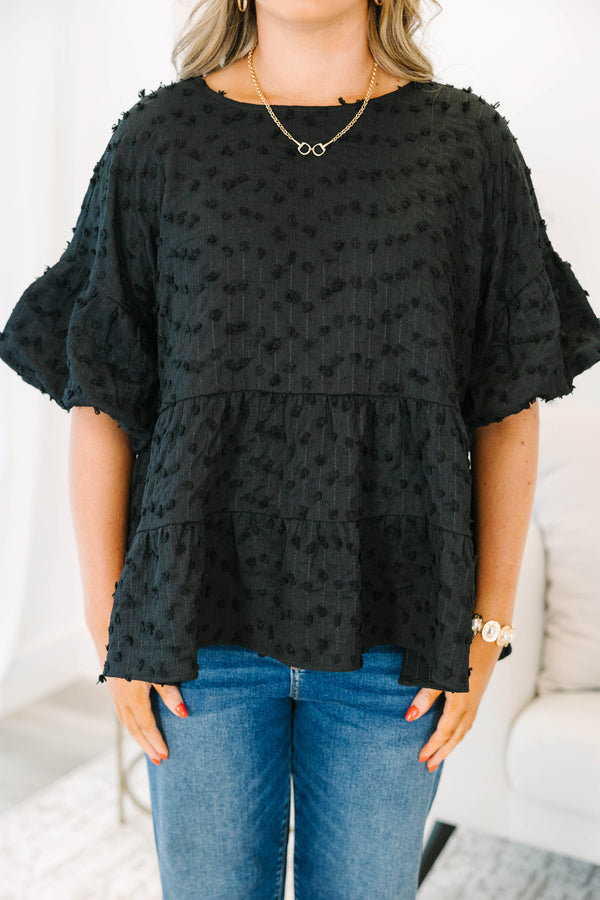 Plus size black textured Swiss dot top with a flowy tiered silhouette and ruffle sleeves.
