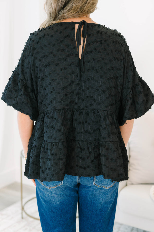 Plus size black textured Swiss dot top with a flowy tiered silhouette and ruffle sleeves.