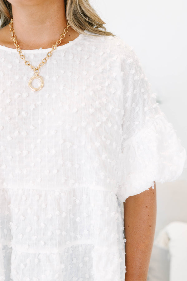 Plus size cream textured swiss dot top with flowy tiered silhouette and ruffle sleeves.