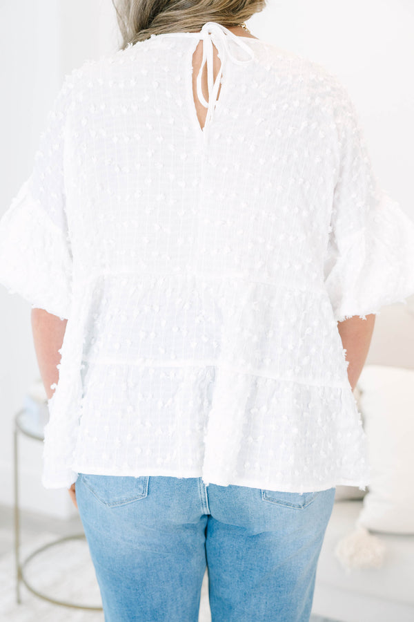 Plus size cream textured swiss dot top with flowy tiered silhouette and ruffle sleeves.