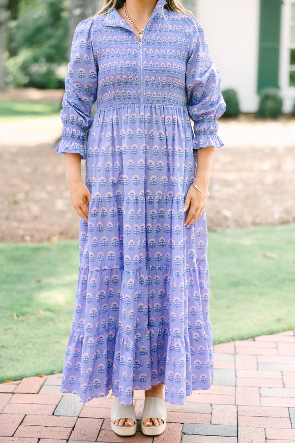 Plus size purple floral maxi dress with a smocked bodice, tiered skirt, and long sleeves.