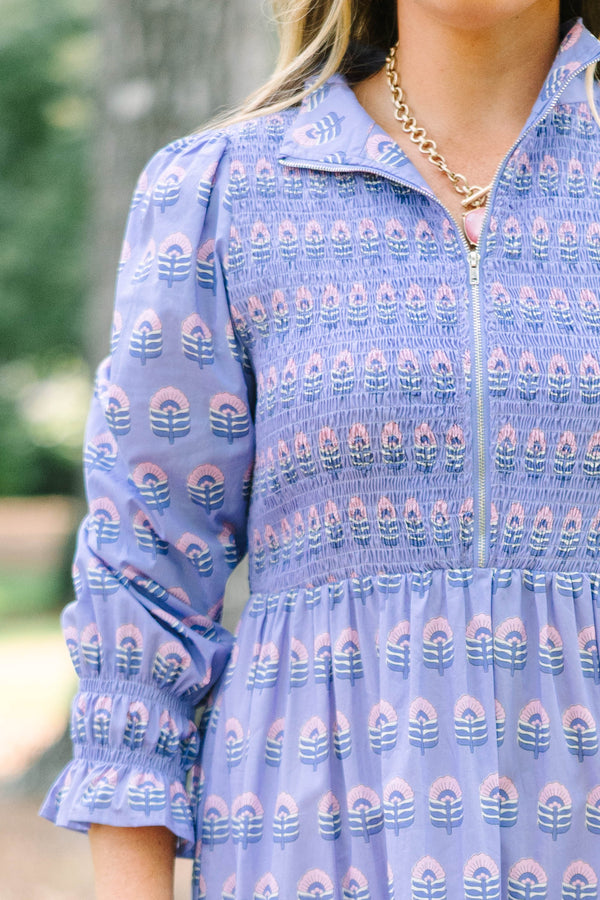 Plus size purple floral maxi dress with a smocked bodice, tiered skirt, and long sleeves.