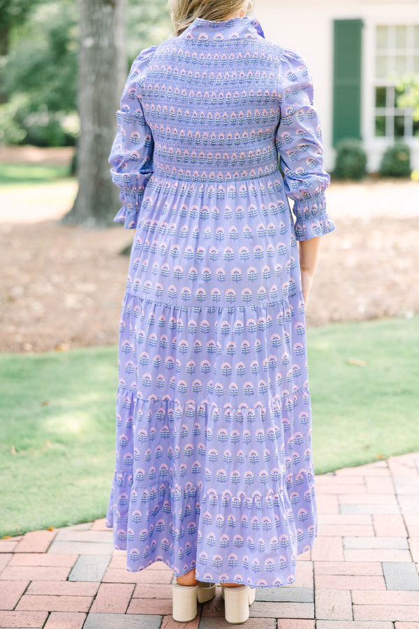 Plus size purple floral maxi dress with a smocked bodice, tiered skirt, and long sleeves.
