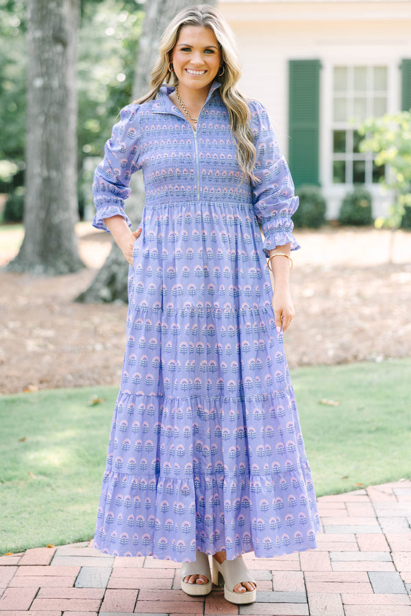 Plus size purple floral maxi dress with a smocked bodice, tiered skirt, and long sleeves.
