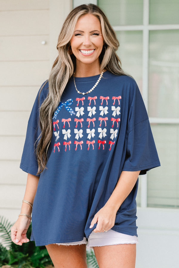 Chic Soul plus size clothing, navy blue short sleeve graphic tee with a flag symbol in the middle made out of bows