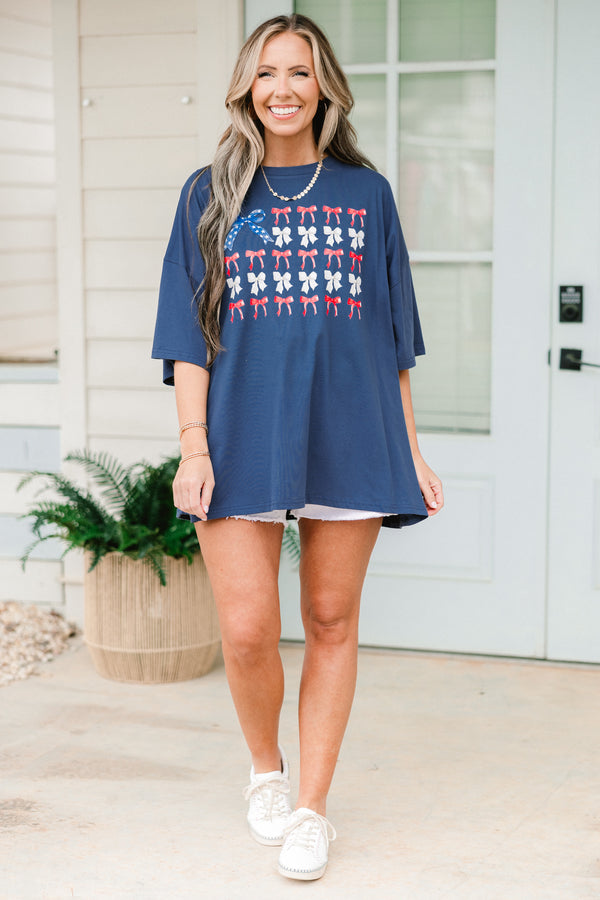 Chic Soul plus size clothing, navy blue short sleeve graphic tee with a flag symbol in the middle made out of bows