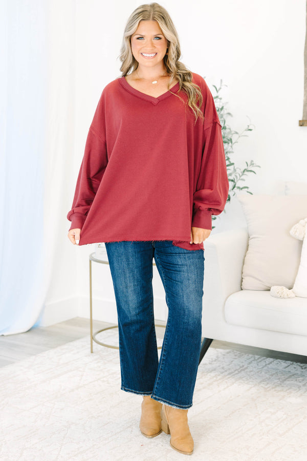 Plus Size burgundy V-neck pullover with long cuffed sleeves and a raw hemline.