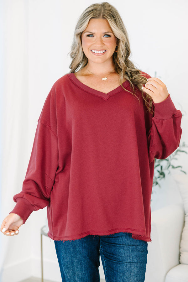 Plus Size burgundy V-neck pullover with long cuffed sleeves and a raw hemline.
