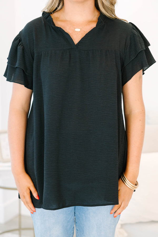 Plus Size black short sleeve top with tiered ruffle sleeves, a v-neckline, and a relaxed fit.