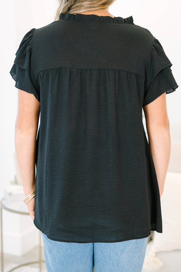 Plus Size black short sleeve top with tiered ruffle sleeves, a v-neckline, and a relaxed fit.