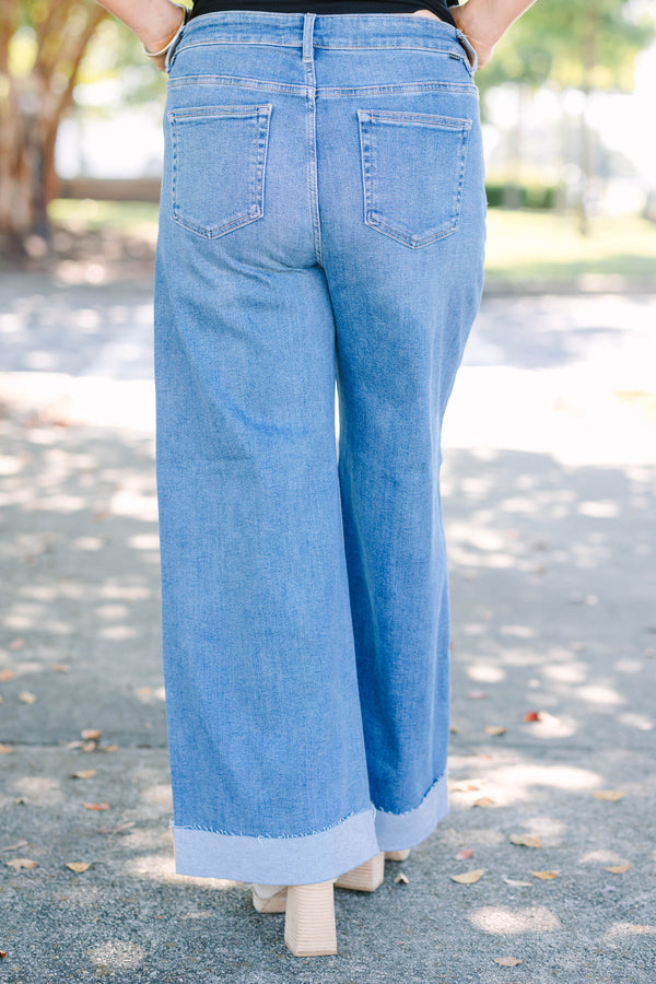 Plus Size medium wash wide leg jeans with a high waist and raw-edge cuffed hems.