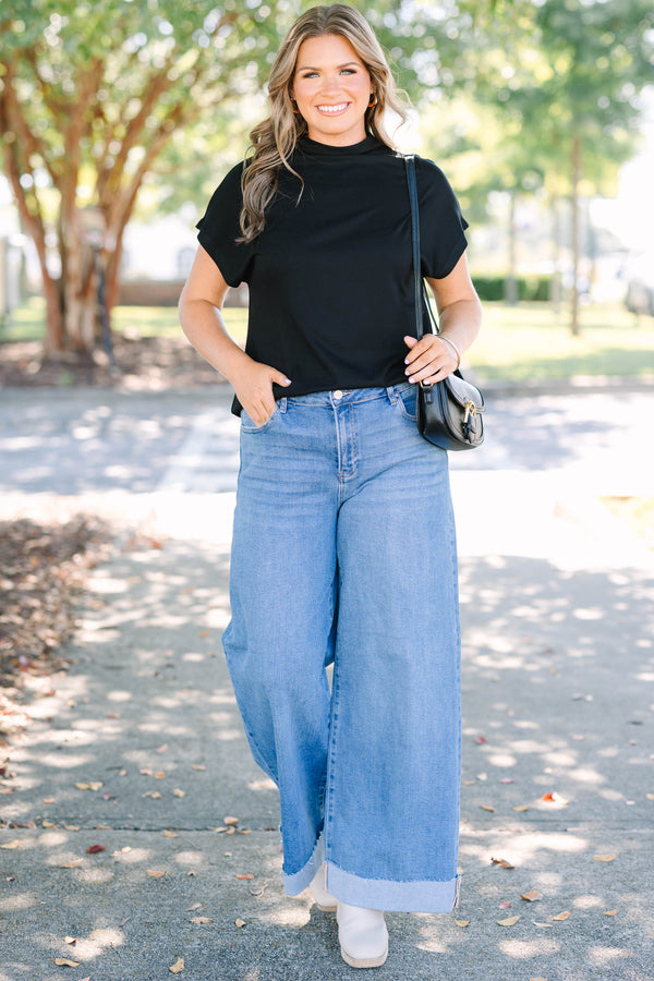 Plus Size medium wash wide leg jeans with a high waist and raw-edge cuffed hems.