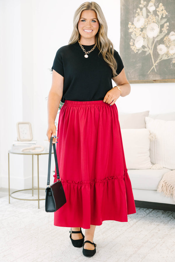 Plus size red midi skirt with a smocked waist and flowy ruffled hem in a soft polyester fabric.