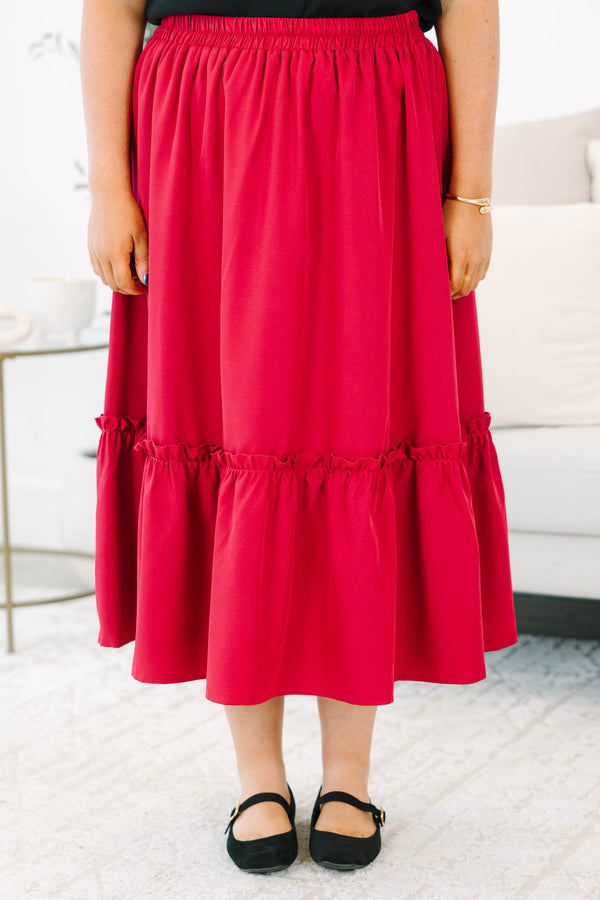 Plus size red midi skirt with a smocked waist and flowy ruffled hem in a soft polyester fabric.
