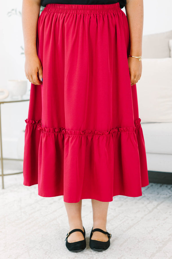 Plus size red midi skirt with a smocked waist and flowy ruffled hem in a soft polyester fabric.