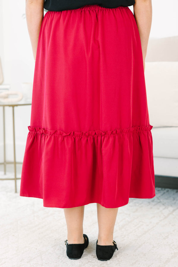 Plus size red midi skirt with a smocked waist and flowy ruffled hem in a soft polyester fabric.