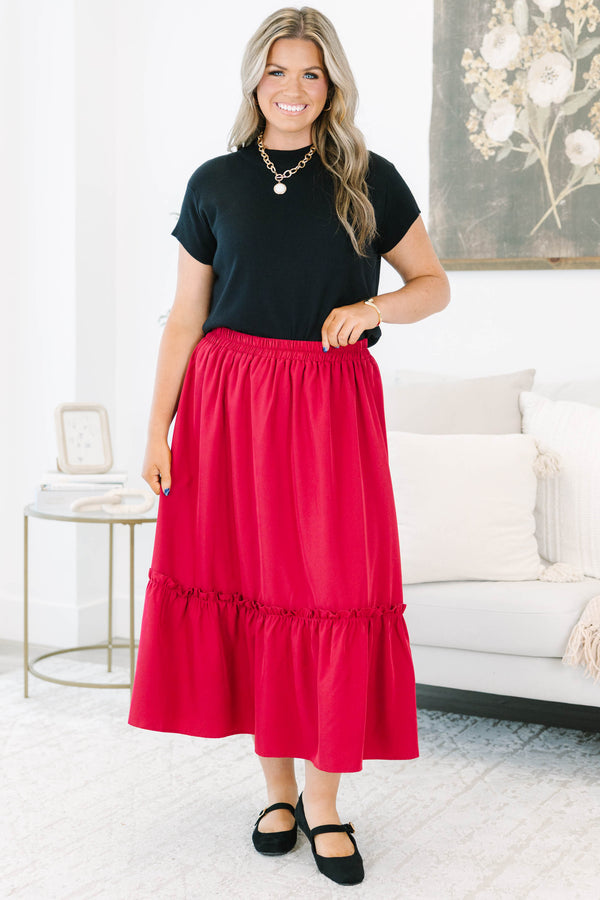 Plus size red midi skirt with a smocked waist and flowy ruffled hem in a soft polyester fabric.