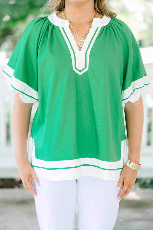 Plus Size kelly green tunic top with white trim, V-neckline, and short flutter sleeves.