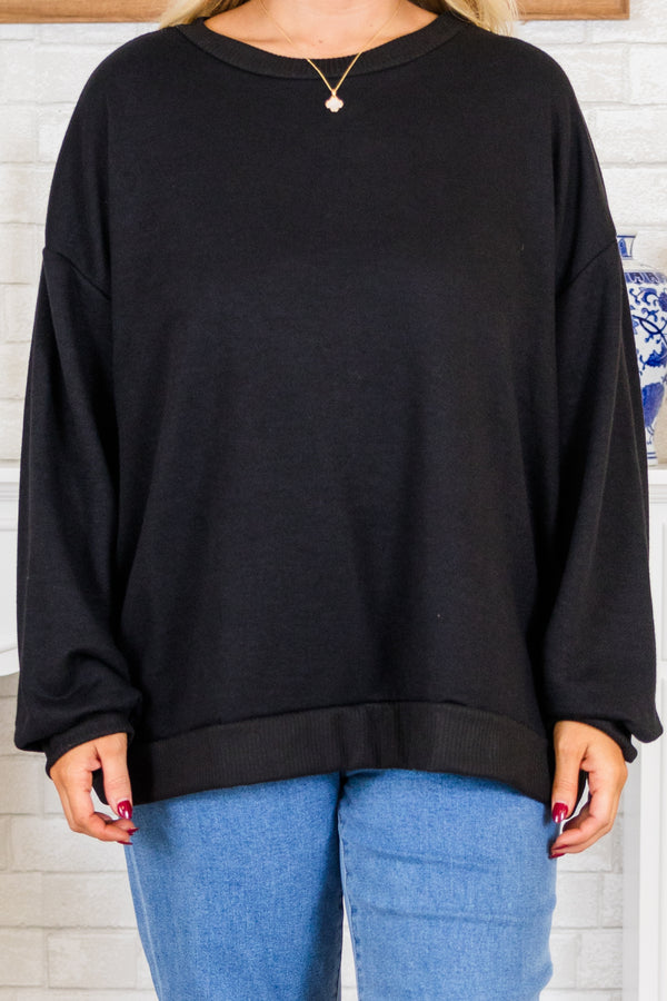 Plus Size black long sleeve top with drop shoulders, ribbed crew neck, cuffs, and banded hem.