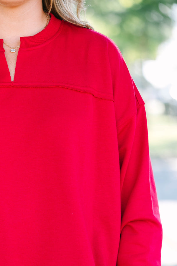 Plus Size crimson tunic sweatshirt with a split v-neckline, dropped shoulders, and raw seam details.