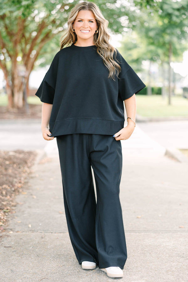 Plus size black ribbed knit lounge set with a boxy short sleeve top and matching pants.