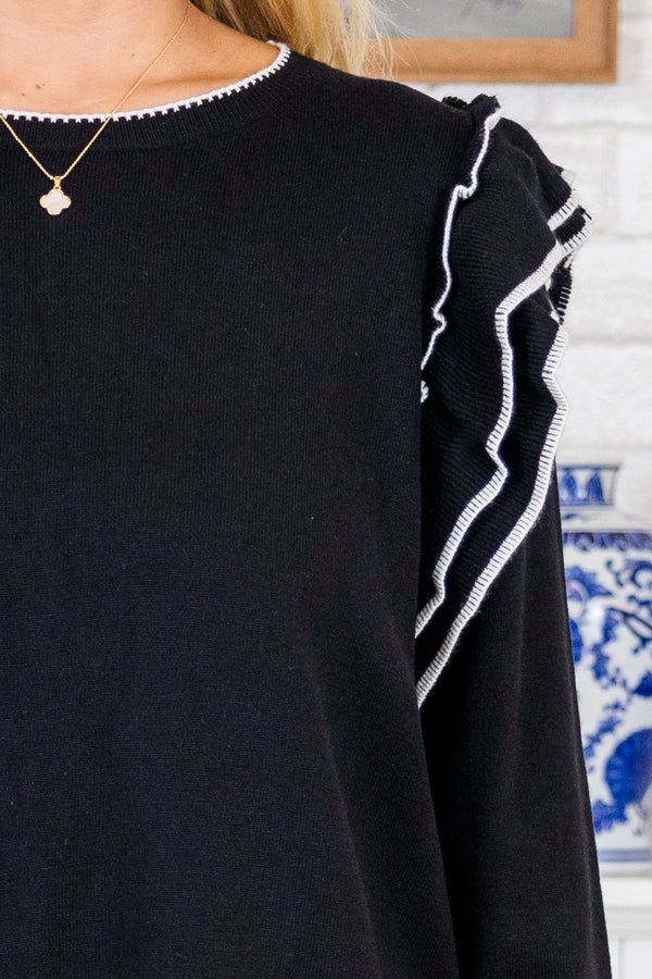 Chic Soul plus size clothing, black long sleeve knit sweater with round neckline and ruffle detail on shoulders with white outlining along ruffles, neckline, sleeves, and bottom