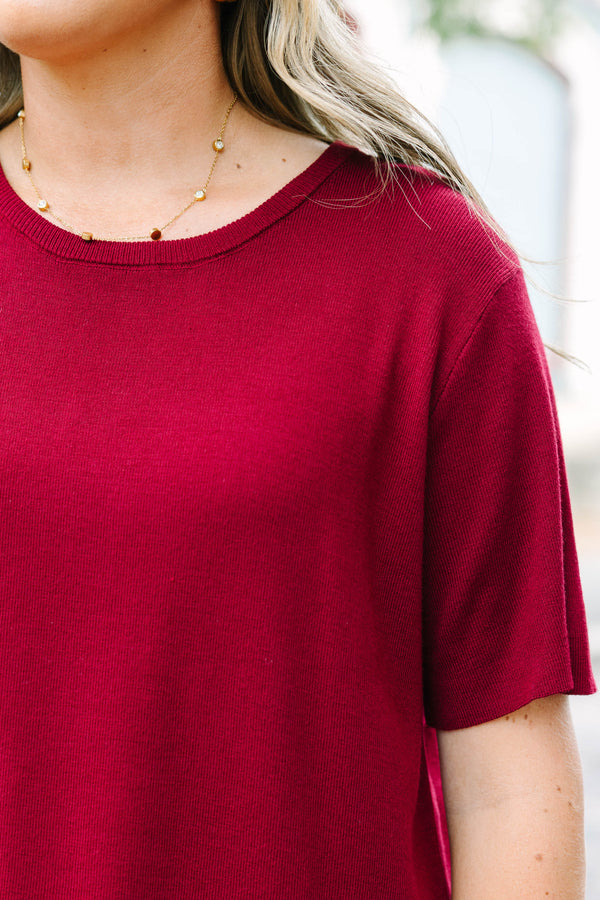 Plus Size burgundy short sleeve knit sweater with a round neckline and relaxed fit.