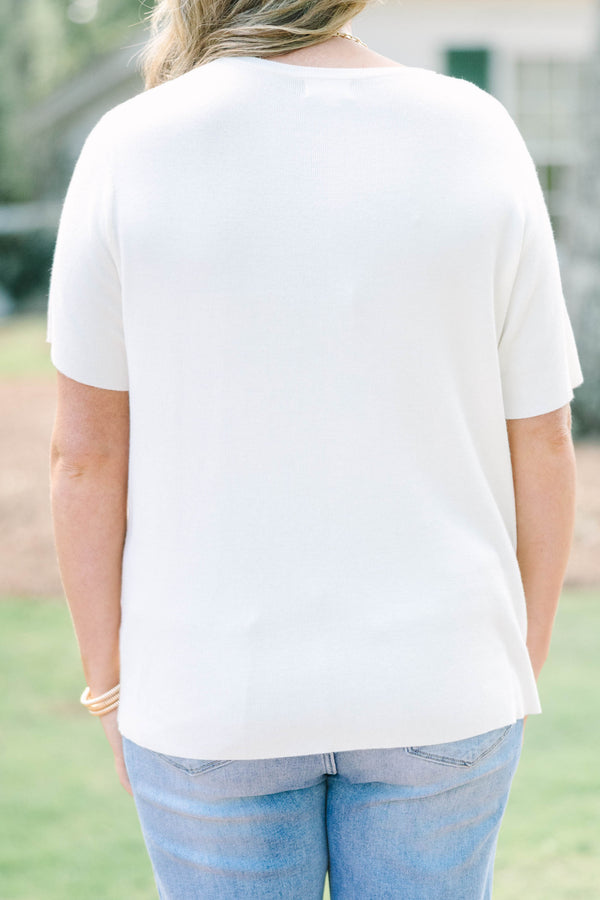 Plus size short sleeve, flowy knit sweater top with a round neck.