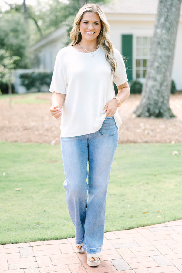 Plus size short sleeve, flowy knit sweater top with a round neck.