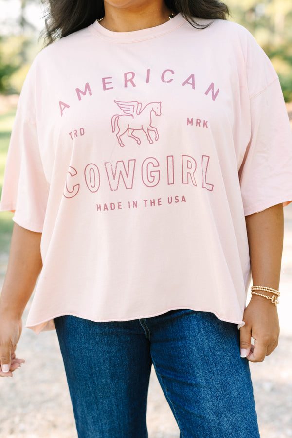 Plus Size blush pink vintage wash tee with an American Cowgirl graphic and unfinished hems.
