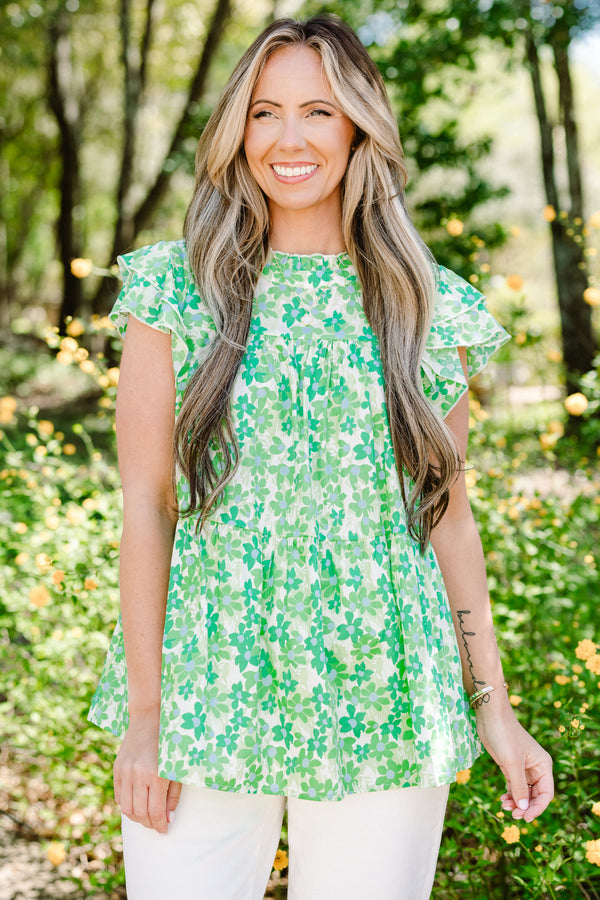 Plus Size green floral print top with flutter sleeves, a high neckline, and a tiered babydoll fit.