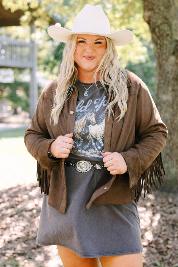 Plus Size brown suede-like jacket with fringe sleeves over a graphic tee and concho belt.