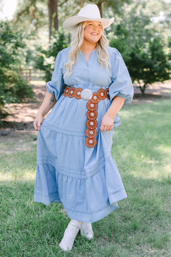 Plus Size blue denim tiered maxi dress with puff sleeves, a v-neckline, and a brown concho belt.