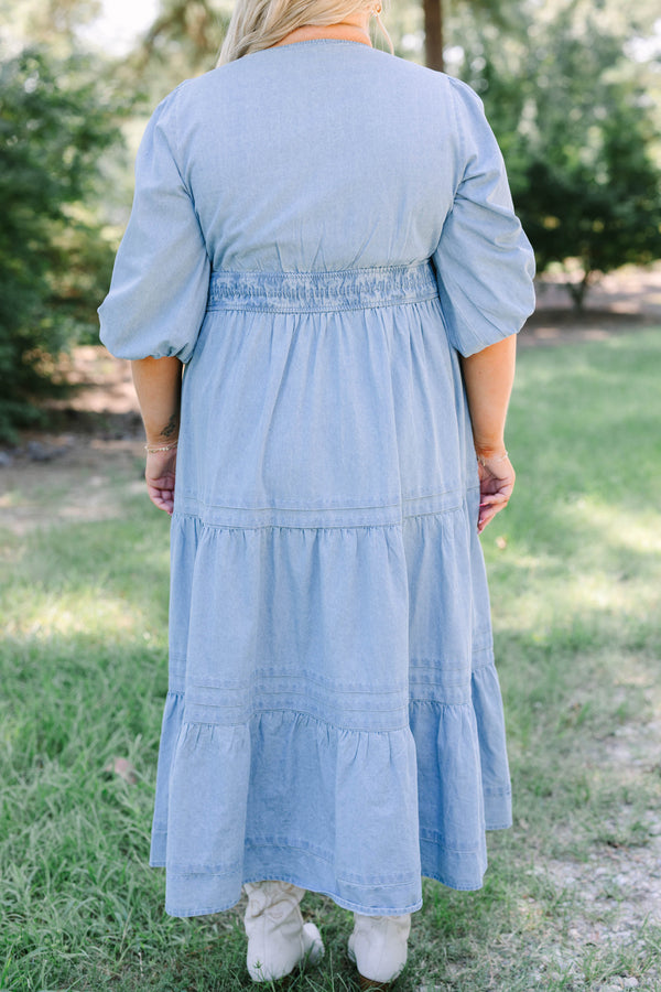 Plus Size blue denim tiered maxi dress with puff sleeves, a v-neckline, and a brown concho belt.