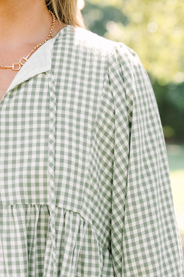 Plus Size green and white gingham babydoll dress with a v-neckline and three-quarter length sleeves.