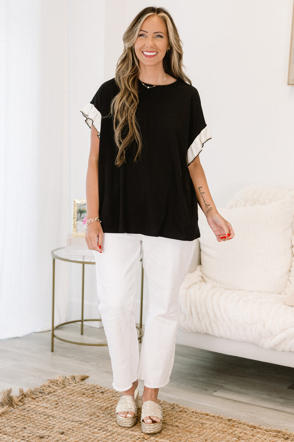 Chic Soul Plus size clothing, black casual top with white flutter sleeves and black stitching detail at the end of each sleeve 
