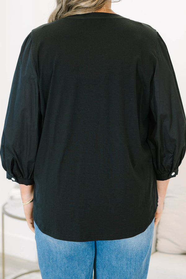 Plus Size black henley top with three-quarter puff sleeves, a button-up neckline, and a relaxed fit.