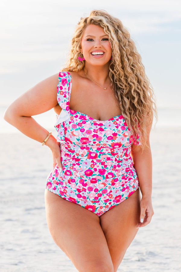 Plus Size one-piece swimsuit with pink floral print and ruffled shoulder straps.