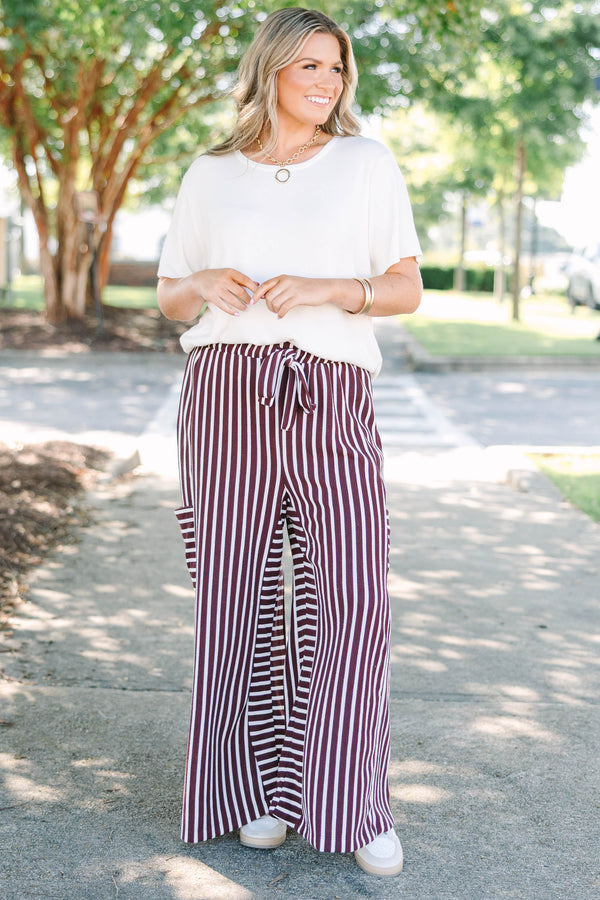Plus size Be A Better You brown and white vertical stripe wide leg pants with a tie waist.