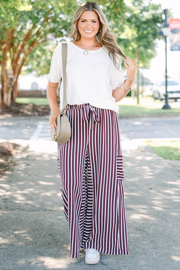 Plus size Be A Better You brown and white vertical stripe wide leg pants with a tie waist.