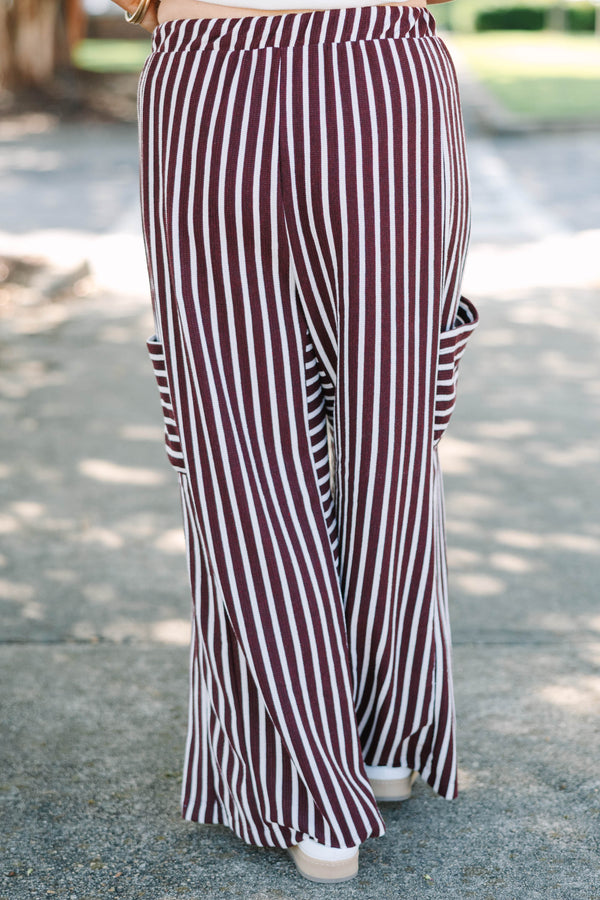Plus size Be A Better You brown and white vertical stripe wide leg pants with a tie waist.