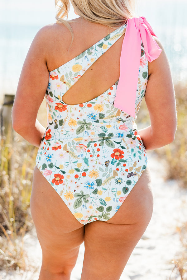 Plus Size one-shoulder swimsuit with a blue floral print and a large pink bow on the strap.