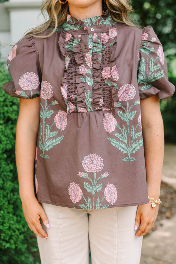 Plus size brown floral top with pink botanical print, ruffled high neck, and short puff sleeves.