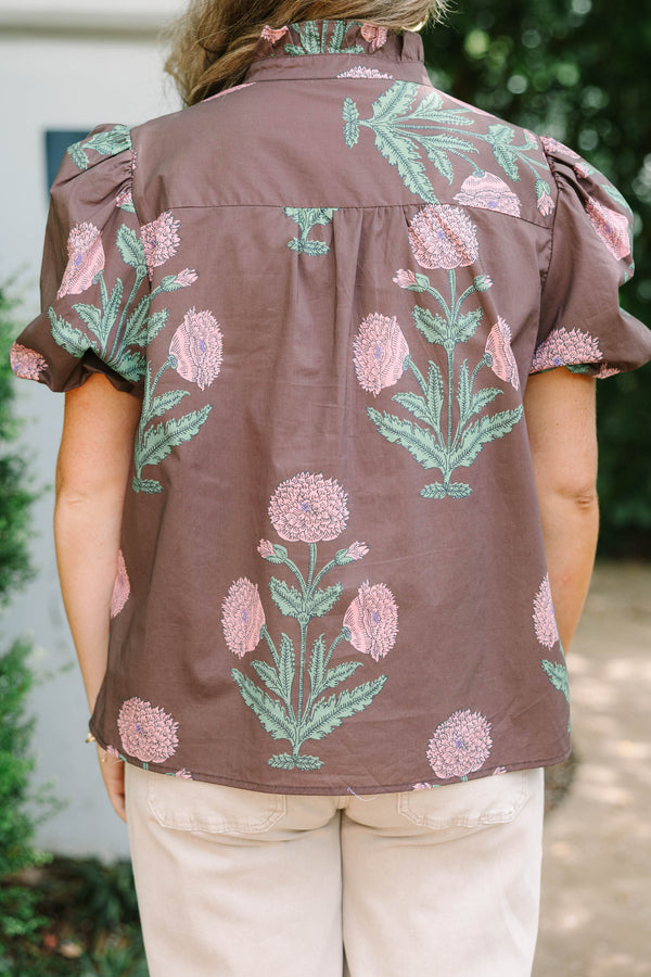 Plus size brown floral top with pink botanical print, ruffled high neck, and short puff sleeves.