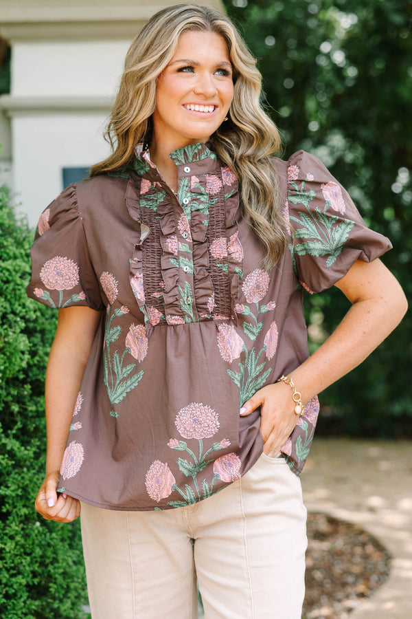 Plus size brown floral top with pink botanical print, ruffled high neck, and short puff sleeves.