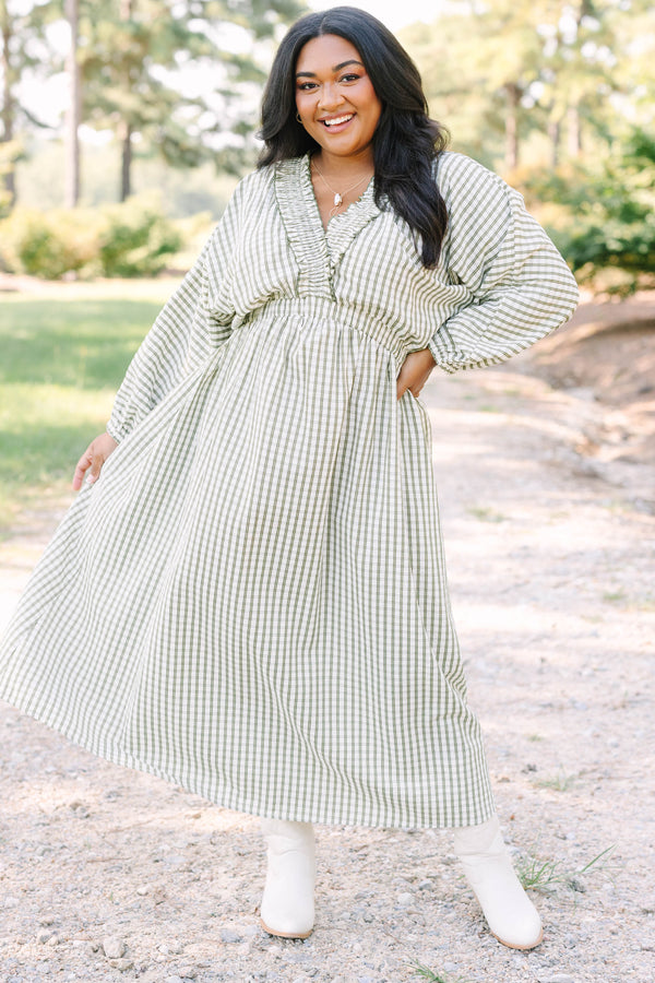 Plus size green and white plaid midi dress with a smocked waist, ruffle neckline, and flowy fit.