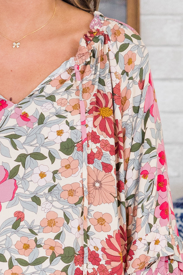 Chic Soul plus size clothing, pink floral top long sleeves that have a ruffle detail at the end of each sleeve and a v-neckline 