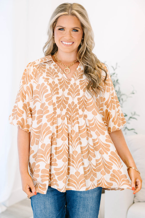 Plus Size tan and white patterned babydoll top with short sleeves and a smocked V-neckline.