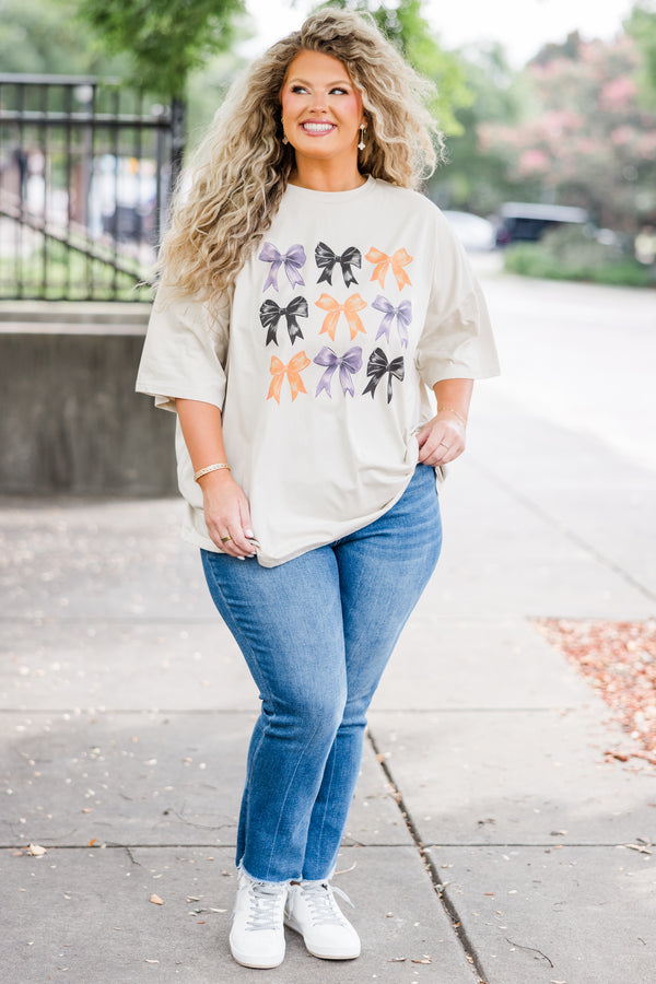 Chic Soul plus size clothing, short-sleeve dust tan graphic boyfriend tee with purple, black, and orange assorted bow graphic art 